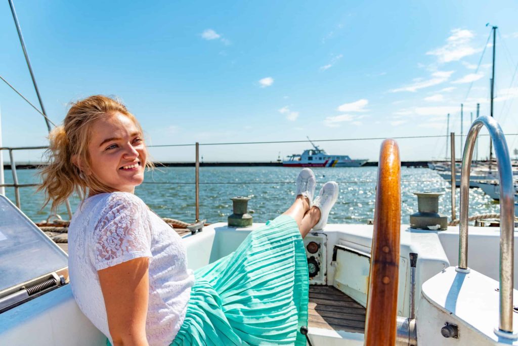 young girl in teal skirt on boat
